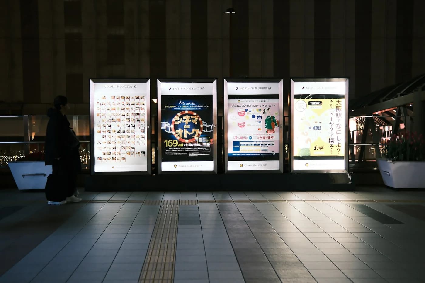 Illuminated advertising displays in an urban station at night